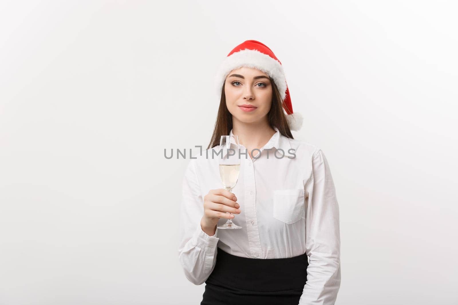 Christmas Celebration - Young beautiful business woman celebrating christmas with glass of champagne.