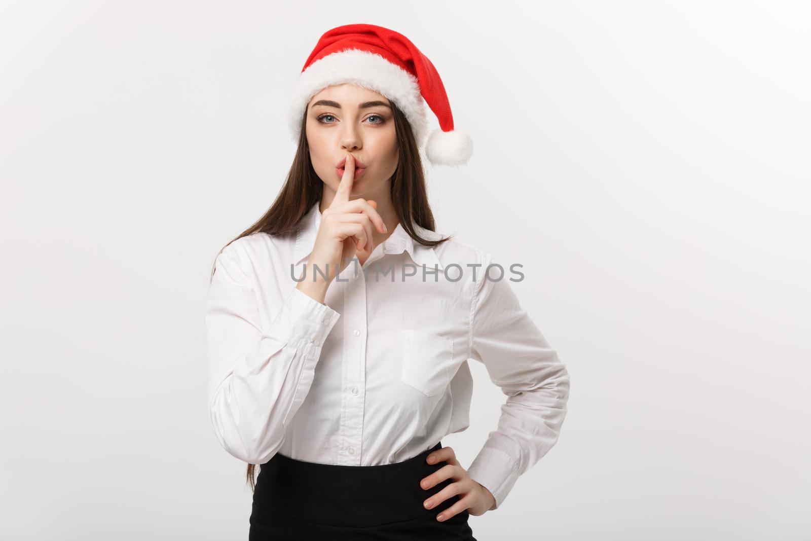 Business Concept - Modern caucasian business woman in the white studio background showing shh sign. by Benzoix