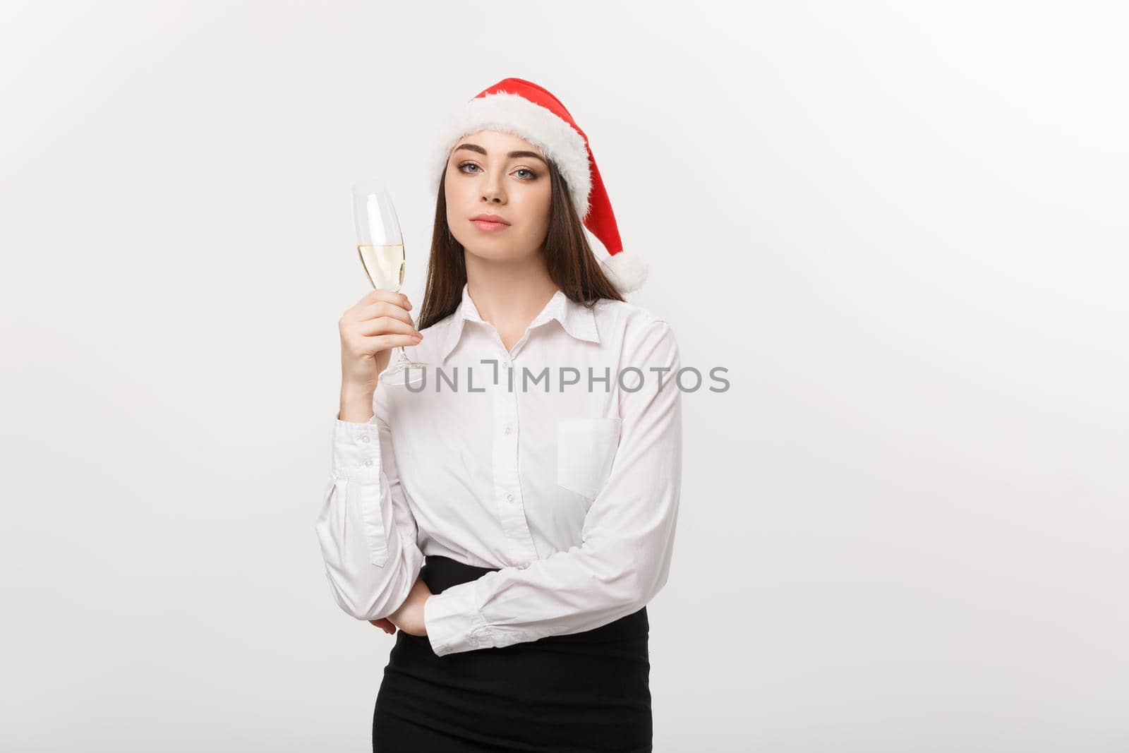 Christmas Celebration - Young beautiful business woman celebrating christmas with glass of champagne. by Benzoix