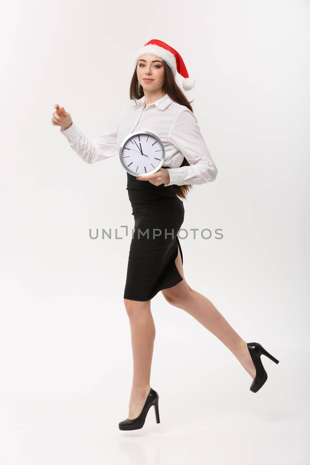 Rush time Concept - beautiful young caucasian woman running with clock isolated on white.