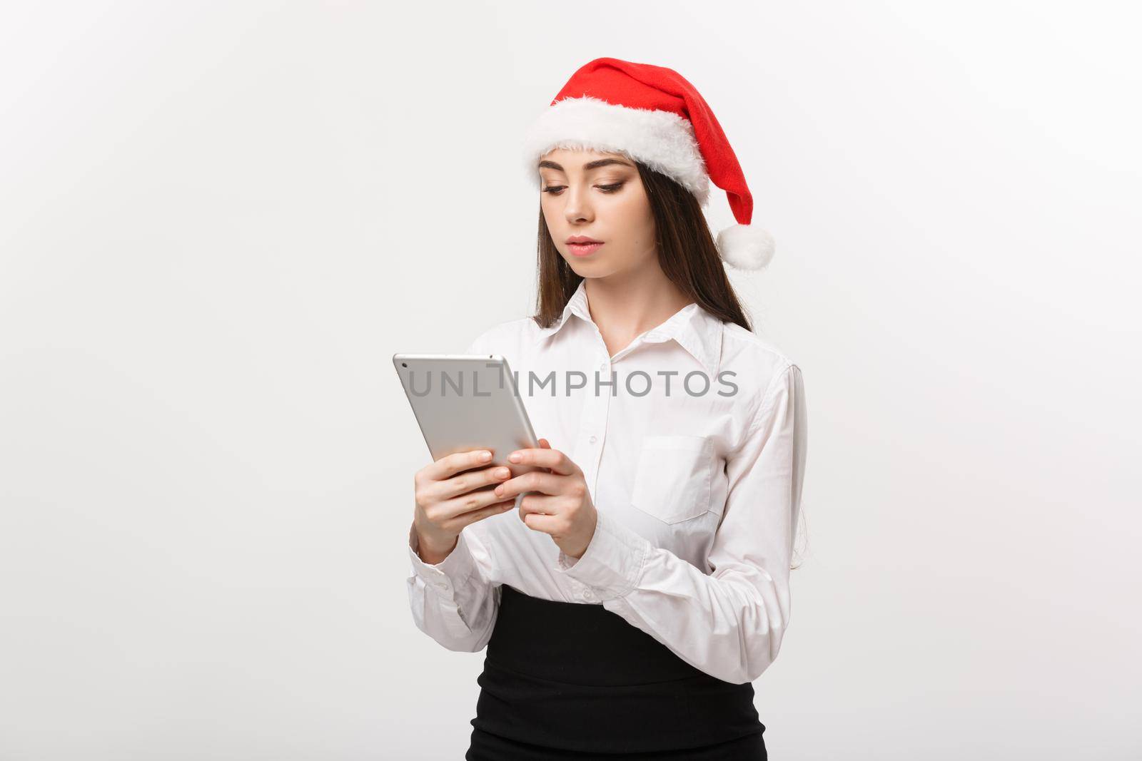 Business Concept - young business woman woking on digital tablet in Christmas day.