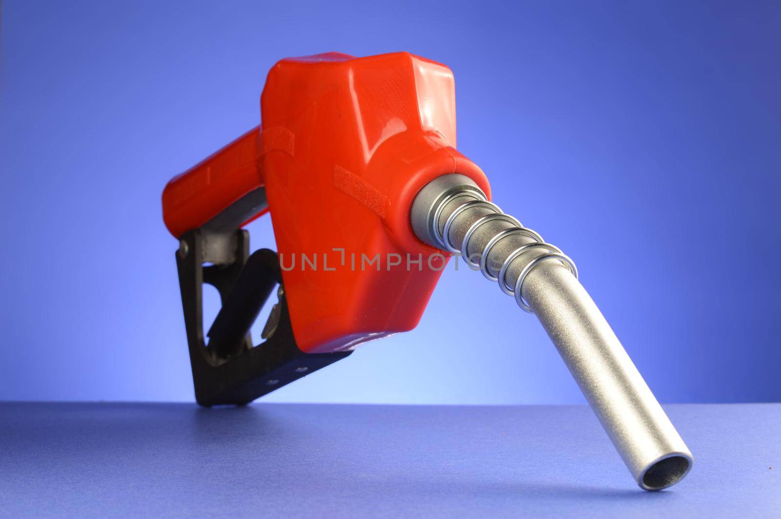 A red gas pump over a blue background.
