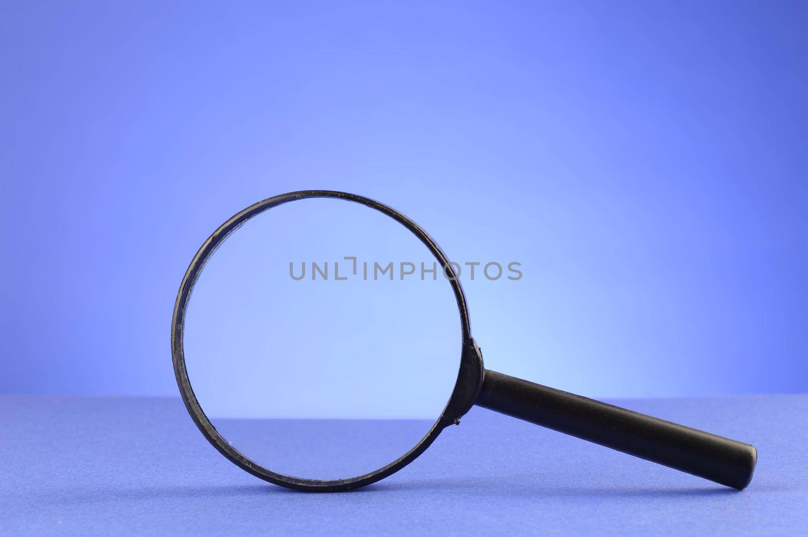 A magnify glass over a blue background for searching the details.