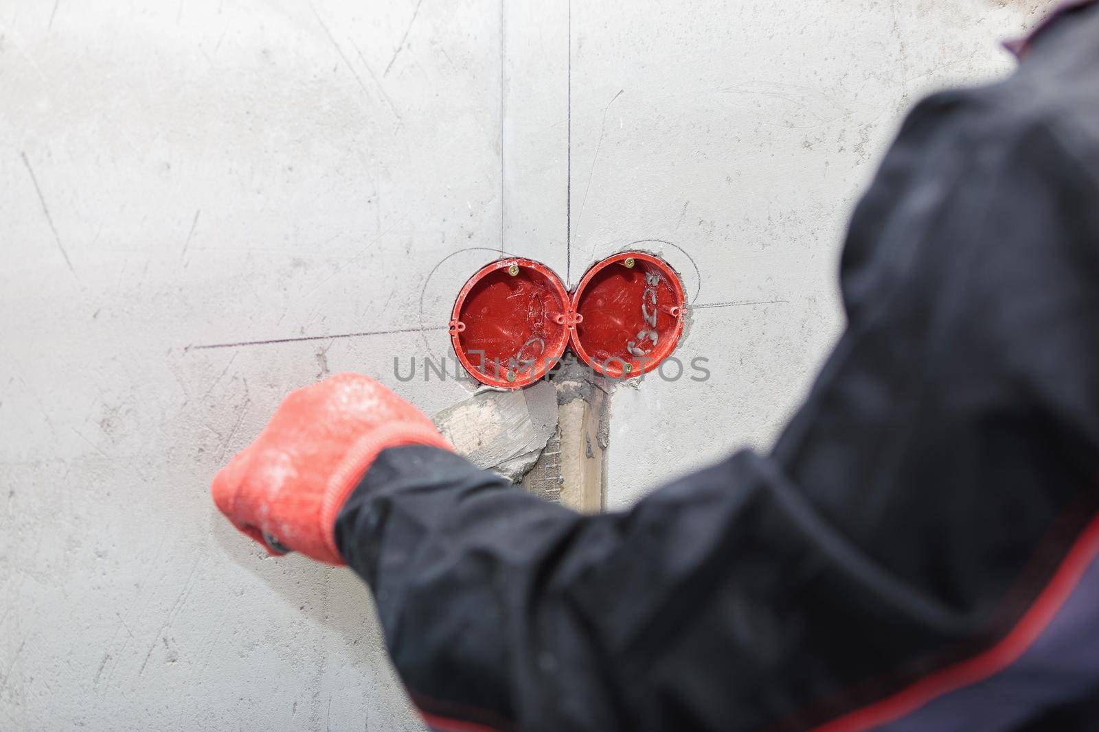The electrician will plaster holes and channels for sockets and wires. Repair of apartments. Close-up
