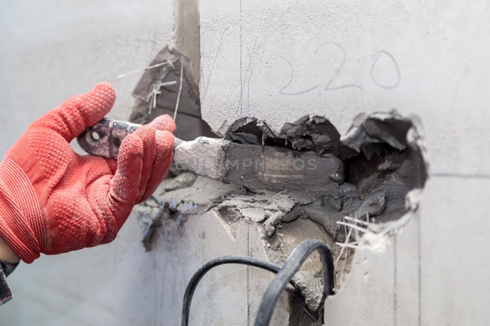 The electrician will plaster holes and channels for sockets and wires. Repair of apartments. Close-up