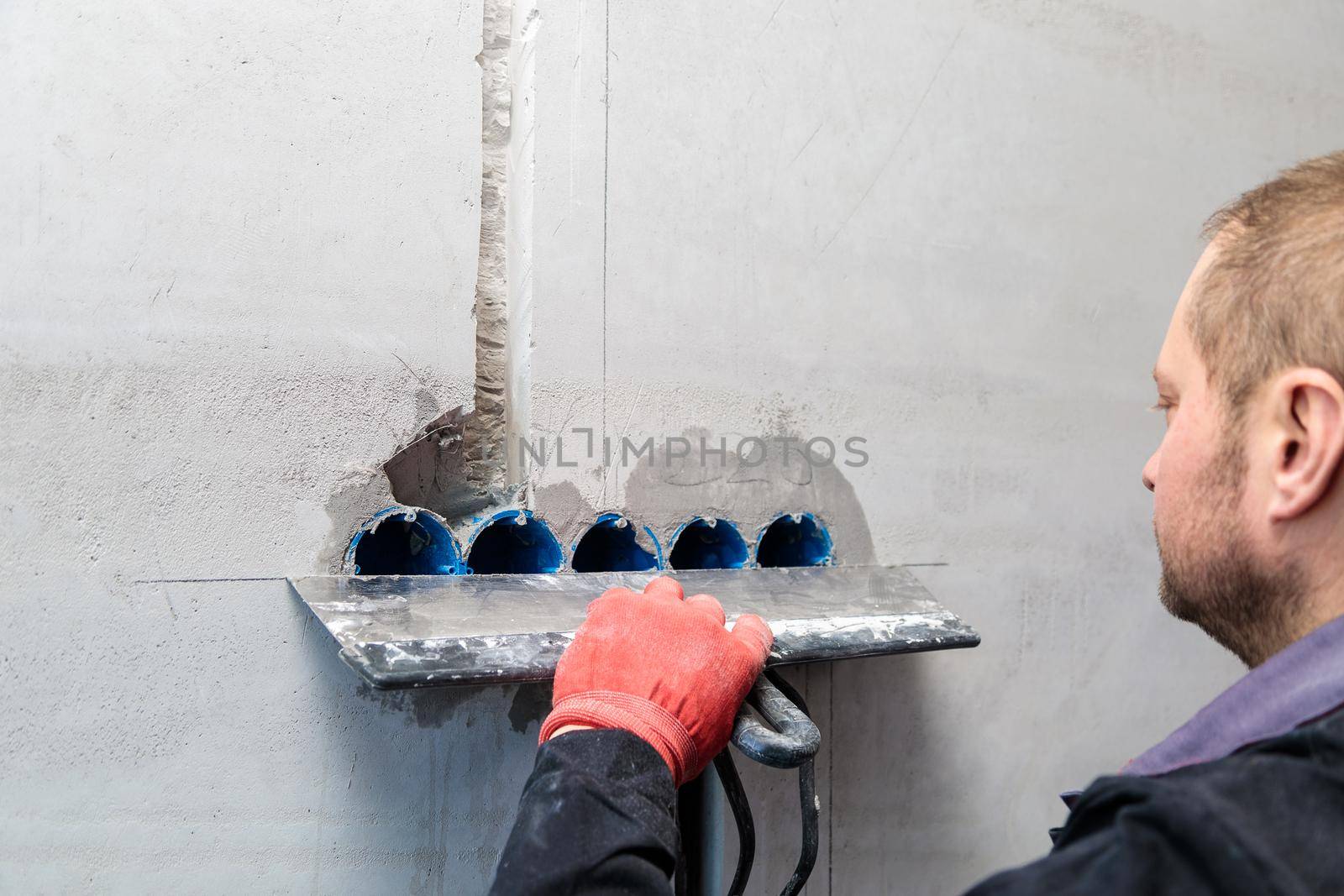 The electrician will plaster holes and channels for sockets and wires. Repair of apartments. Close-up