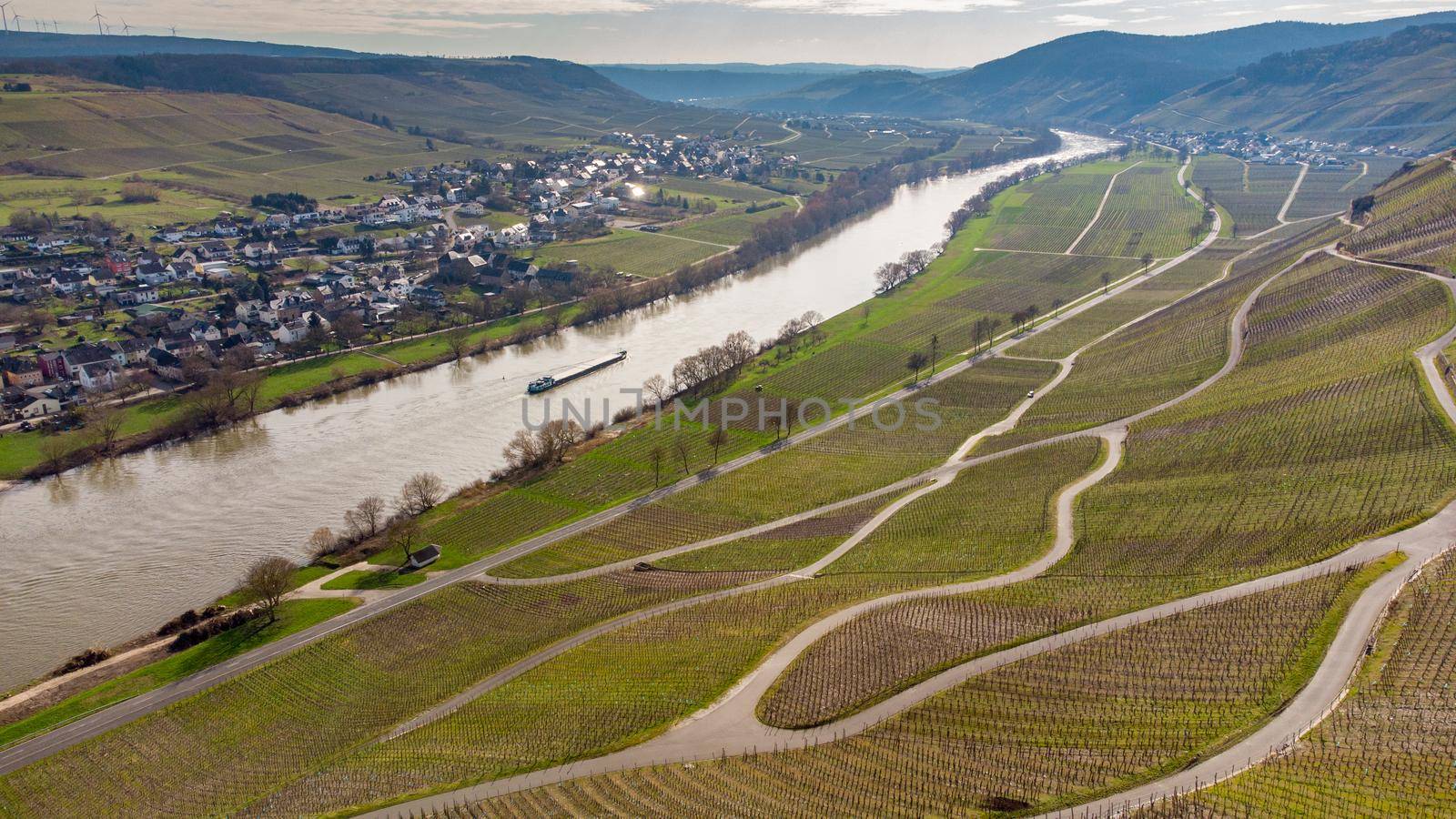 Aerial view of the river Moselle valley with cargo ship and the village Brauneberg 