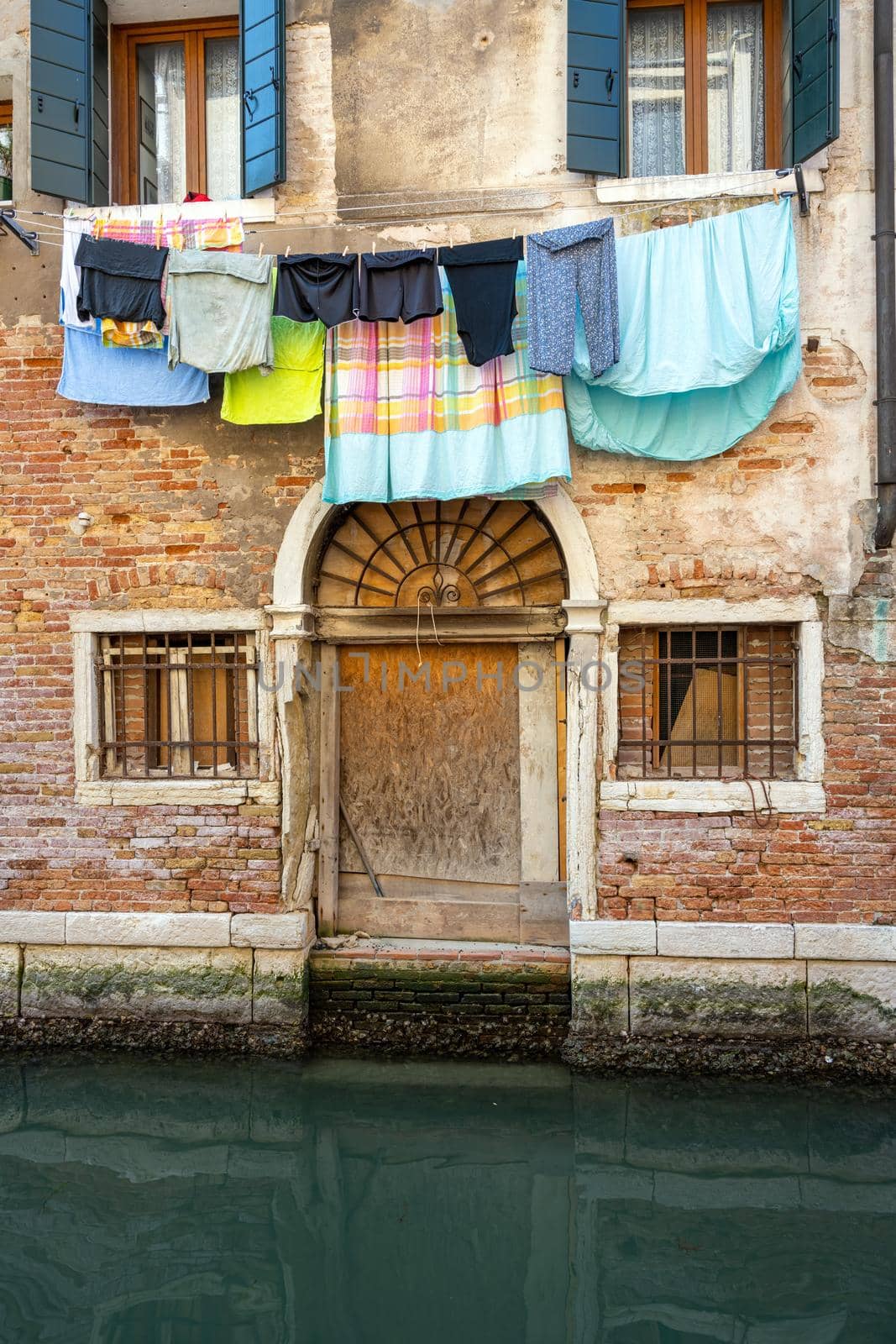 Small canal in Venice with clothesline and laundry