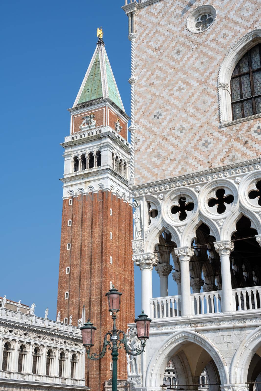 Detail of the famous Doges Palace with the Campanile in the back, seen in Venice, Italy