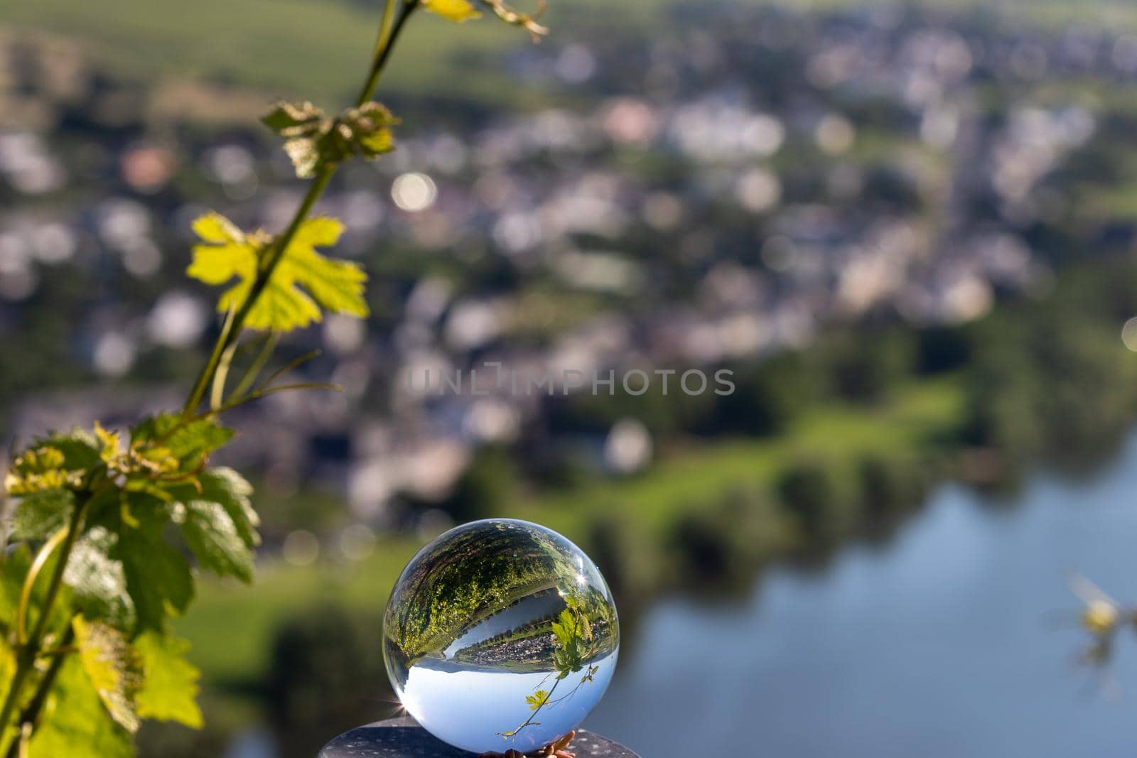 Crystal ball shows landscape of river moselle and defocused valley in background