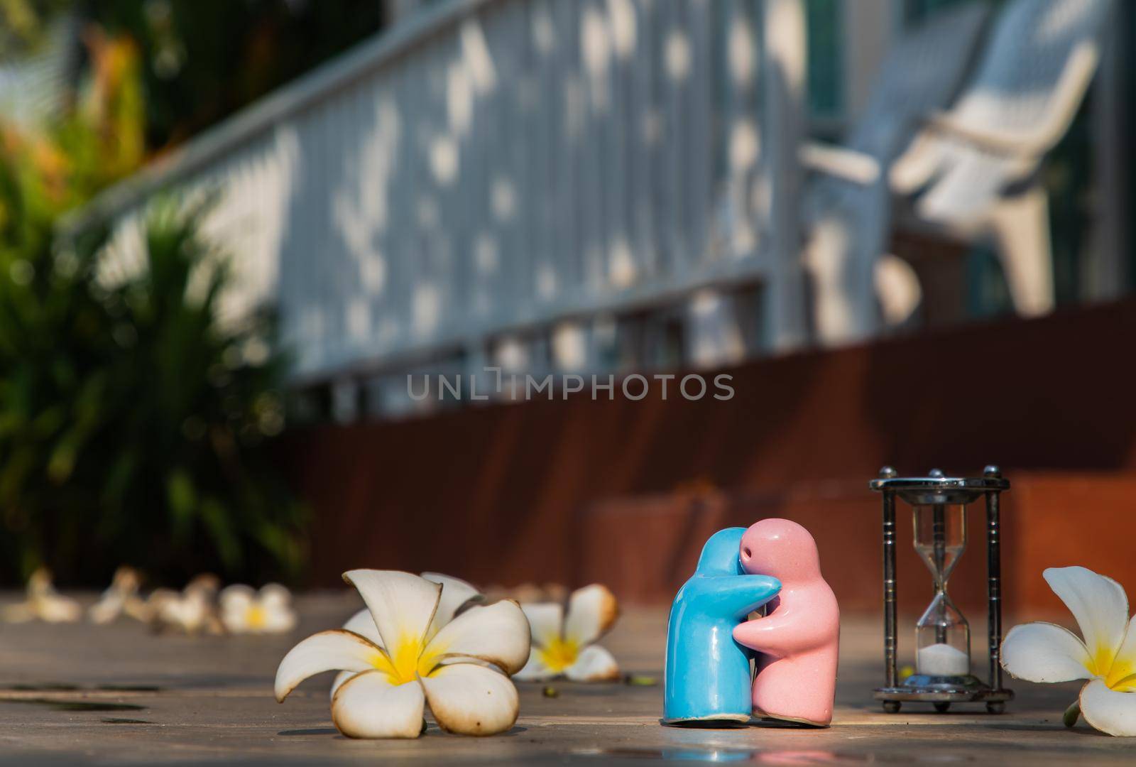 Blue and pink ceramic couple dolls hug with each other on stone background. Concept for anniversary, Wedding and eternal love concept, Romance wedding or Valentine’s day.