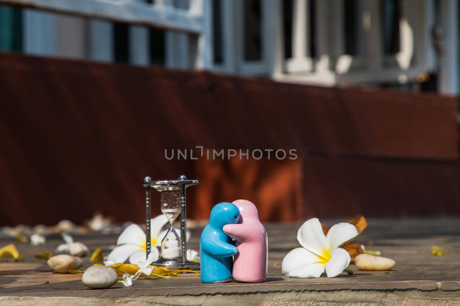 Blue and pink ceramic couple dolls hug with each other on stone background. Concept for anniversary, Wedding and eternal love concept, Romance wedding or Valentine’s day.
