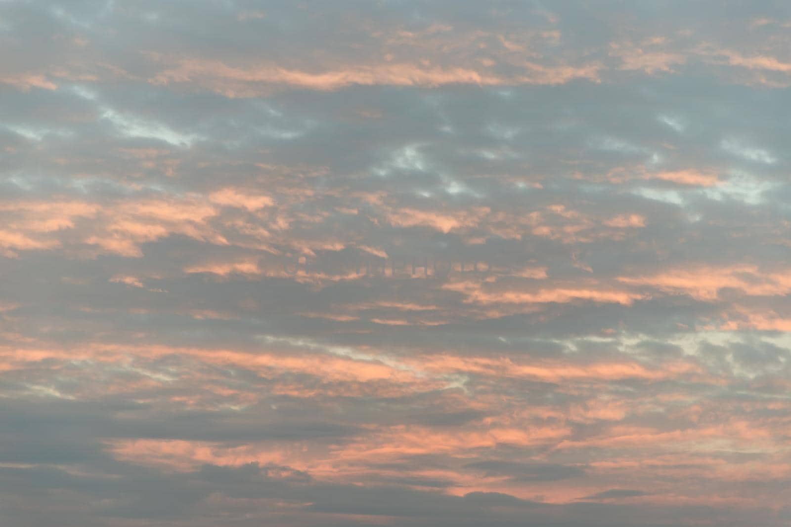 The softness of the clouds and the brightness of the beautiful sky. Light blue clouds and orange on background, Relaxing feeling and inspirational. Copy space, No focus, specifically.