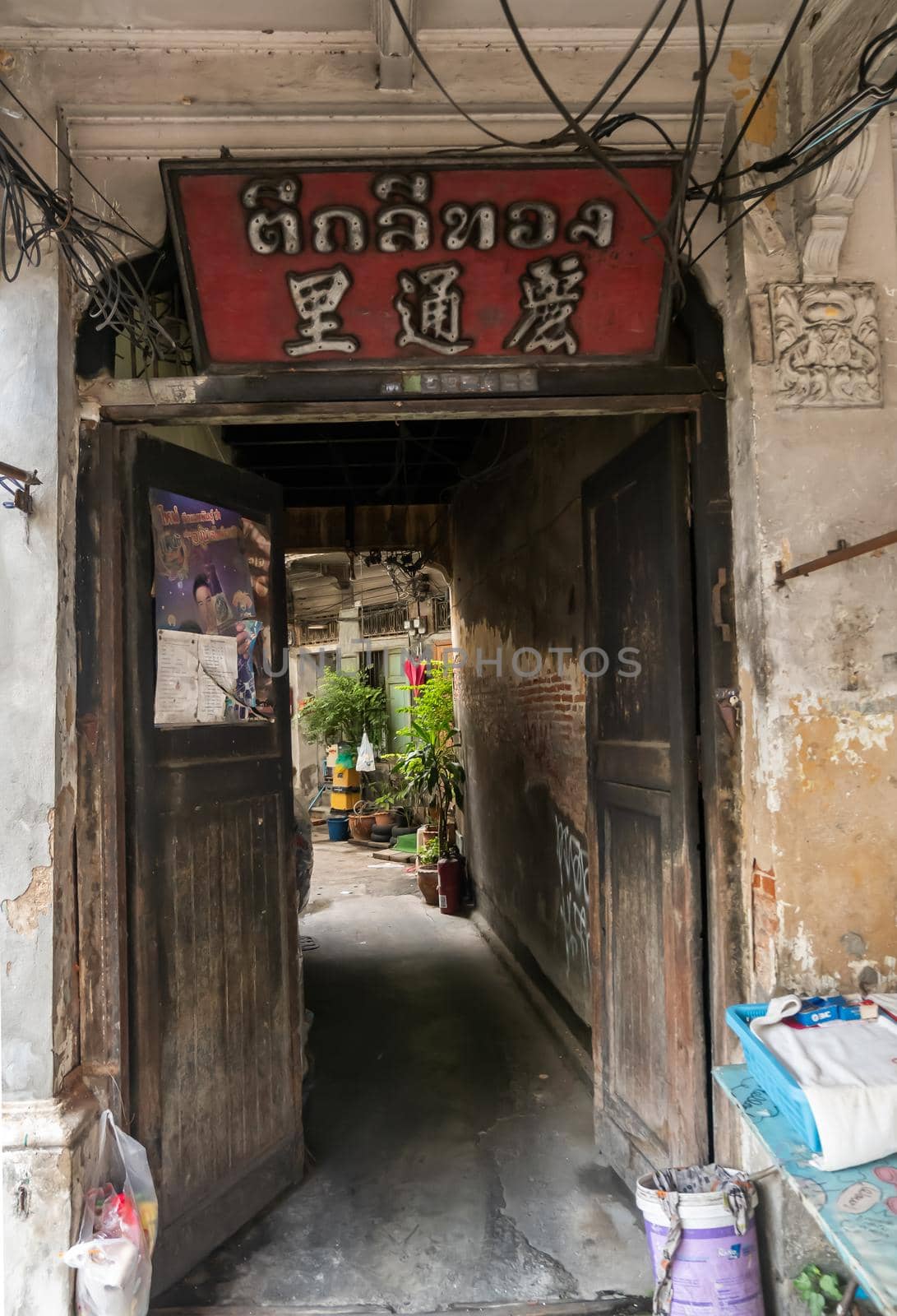 Bangkok, Thailand - Jan 14, 2015 : The light that shines down at the old wall of narrow street in the old wooden village. No focus, specifically.