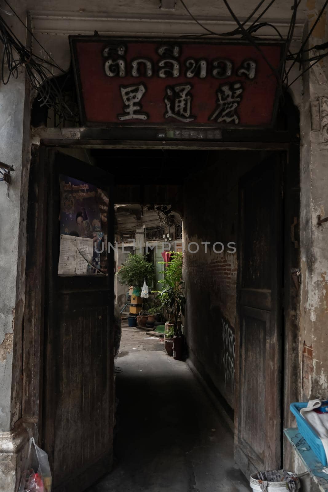 Bangkok, Thailand - Jan 14, 2015 : The light that shines down at the old wall of narrow street in the old wooden village. Focus and blur.