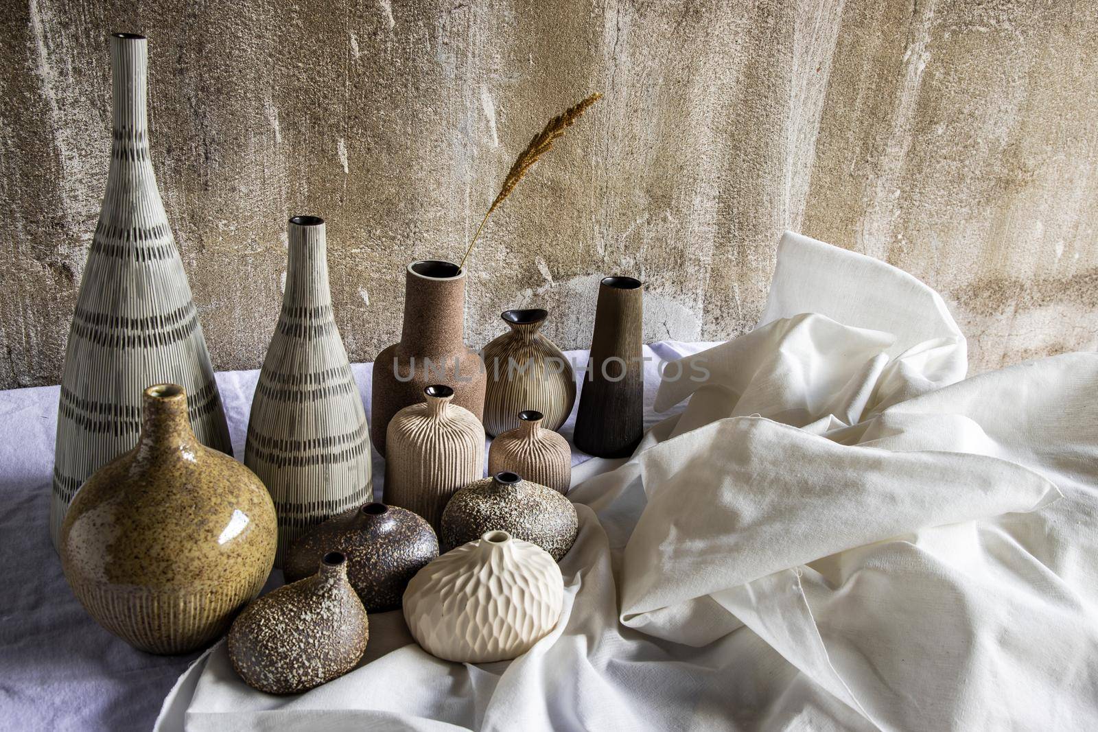 Handmade Assorted Many Different Ceramic Vases on white table. Home decor, Space for text.