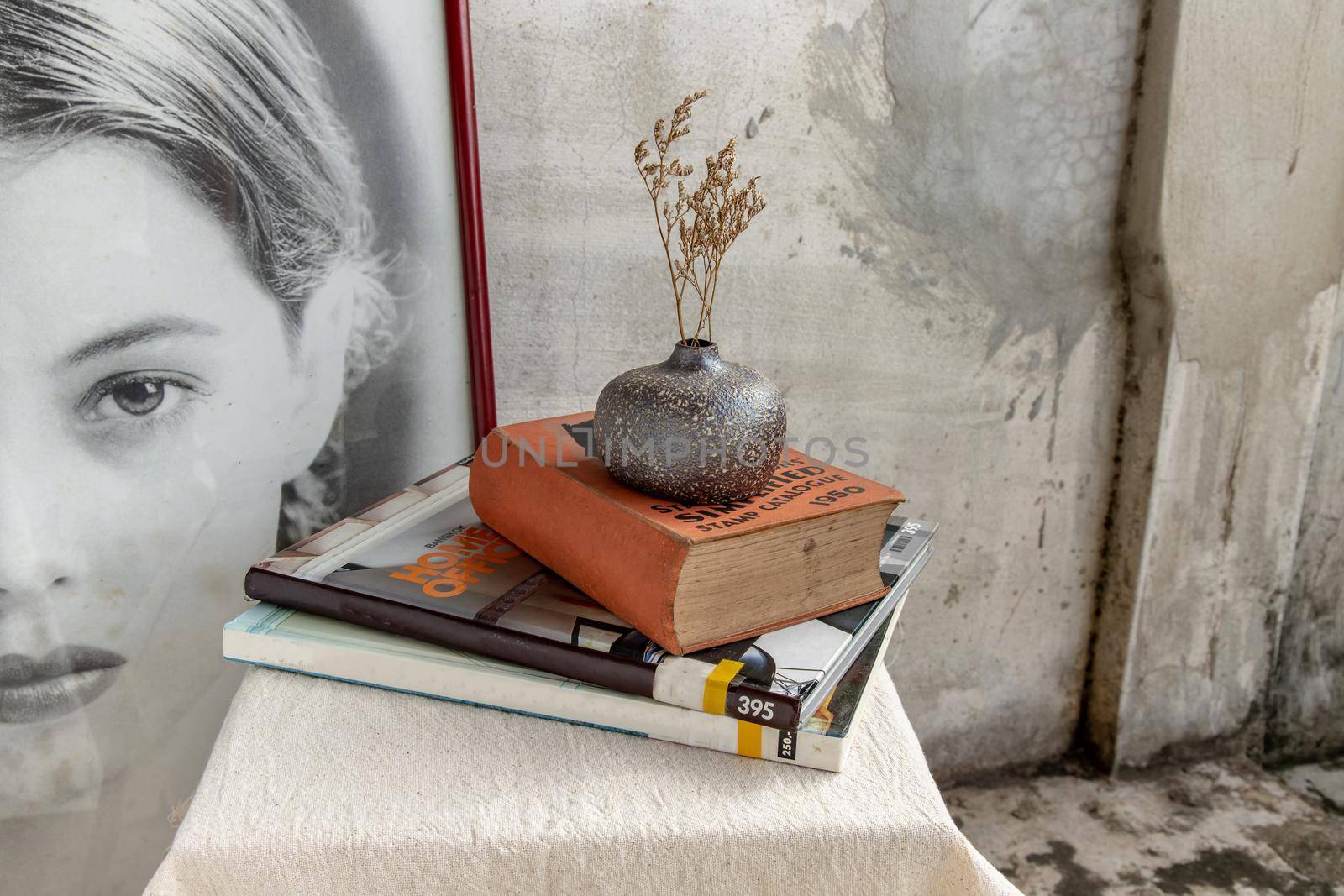 Bangkok, Thailand - Sep 26, 2020 : Dried flowers in Handmade Ceramic Vases and books on table. Home decor, Space for text.