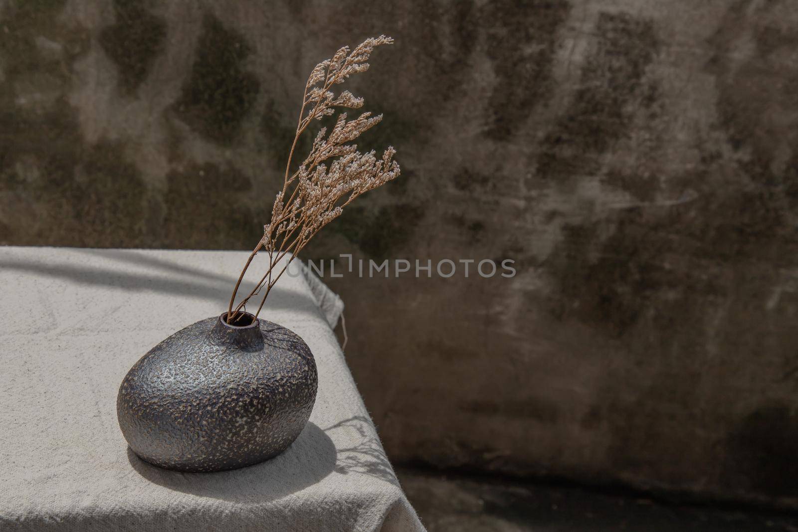 Dried flowers in Handmade Ceramic Vases on table. Home decor, Space for text.
