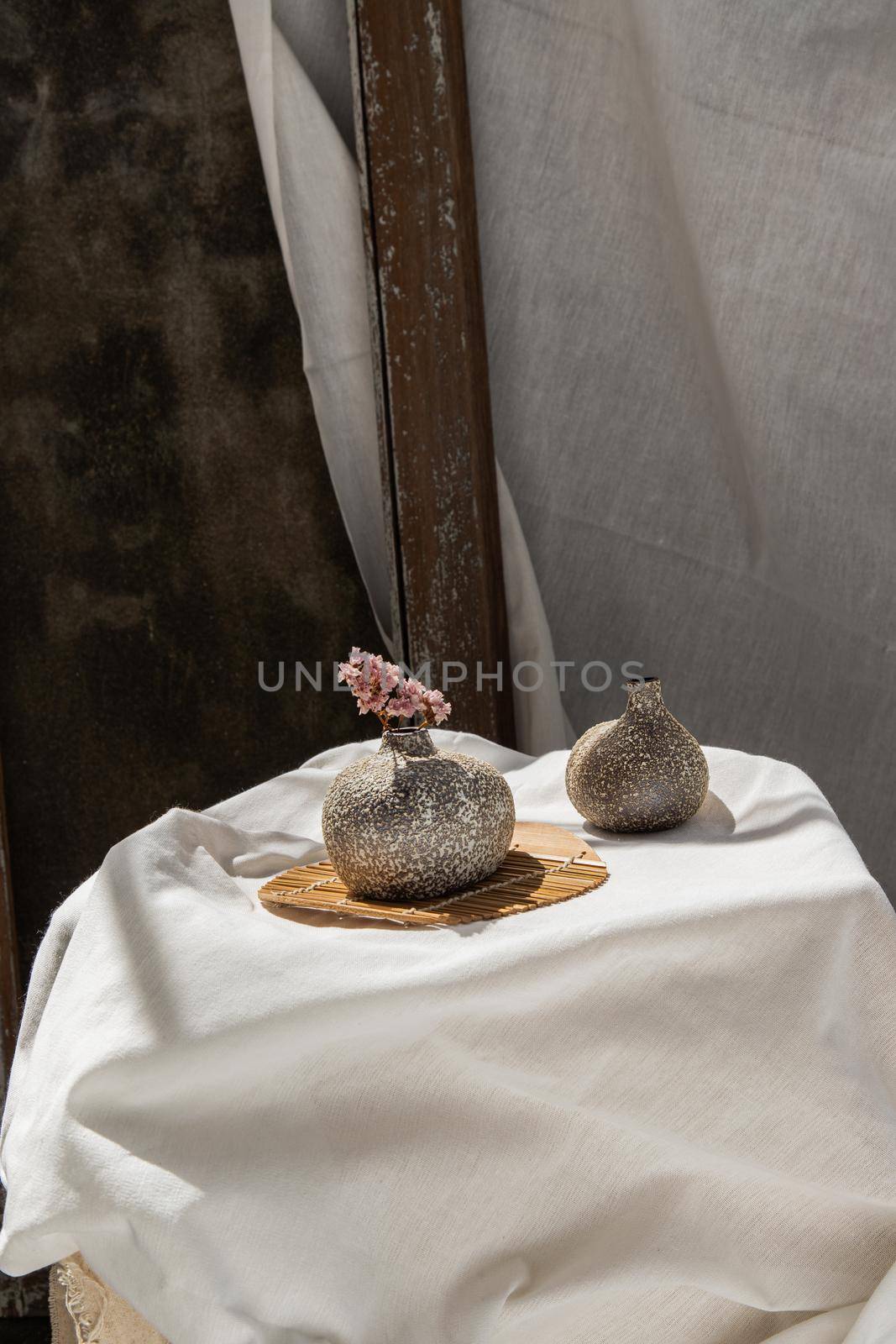 Dried flowers in Handmade Double Ceramic Vases on table. Home decor, Space for text.