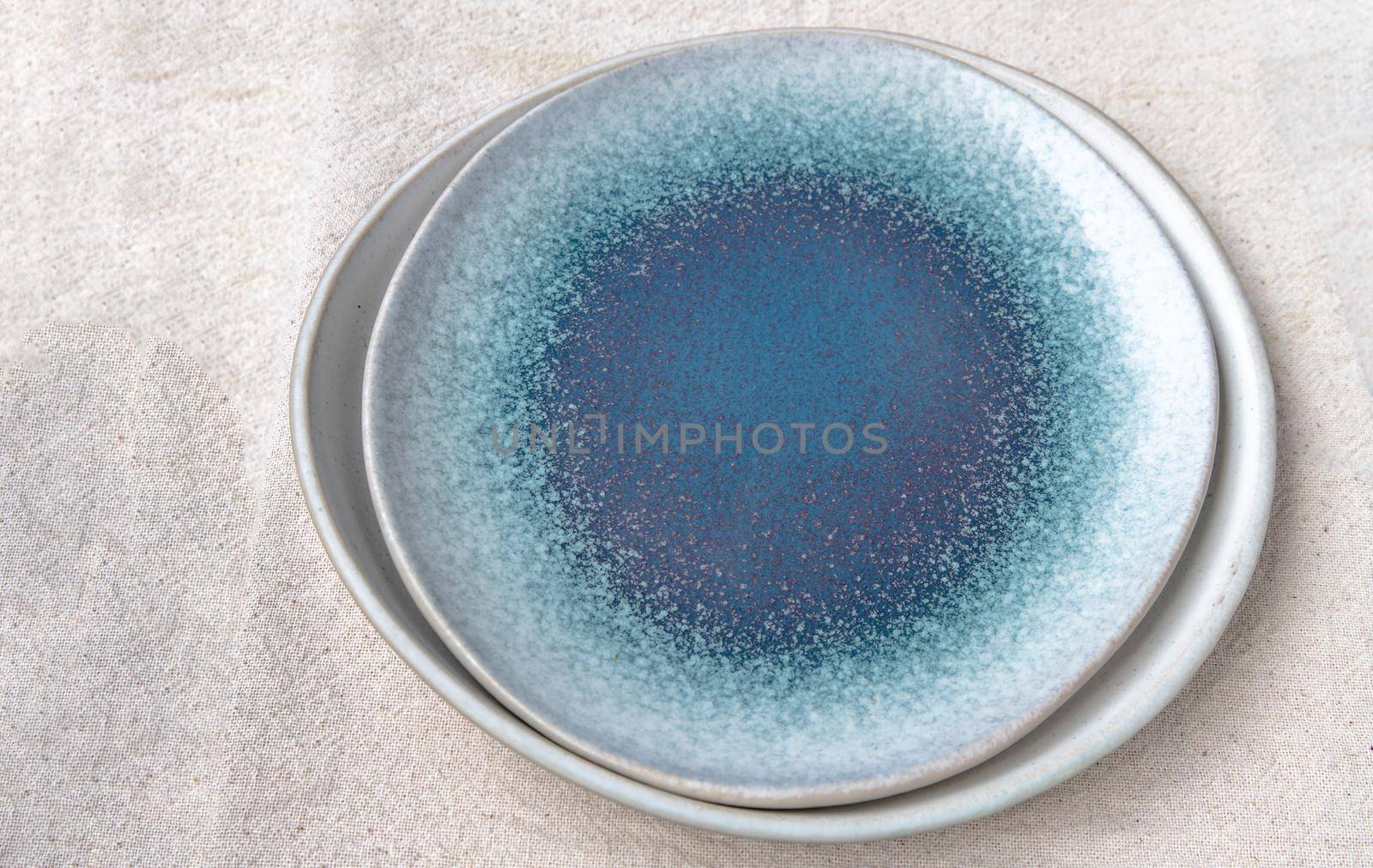 Set of Ceramic Plates on Calico. Ceramic tableware, Beautiful arrangement, Copy space.