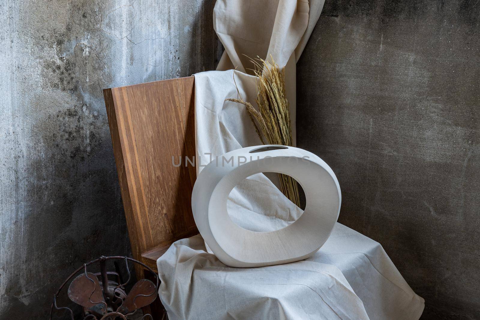 Beautiful ceramic white vase handmade on wooden chair. Home decor, Space for text.