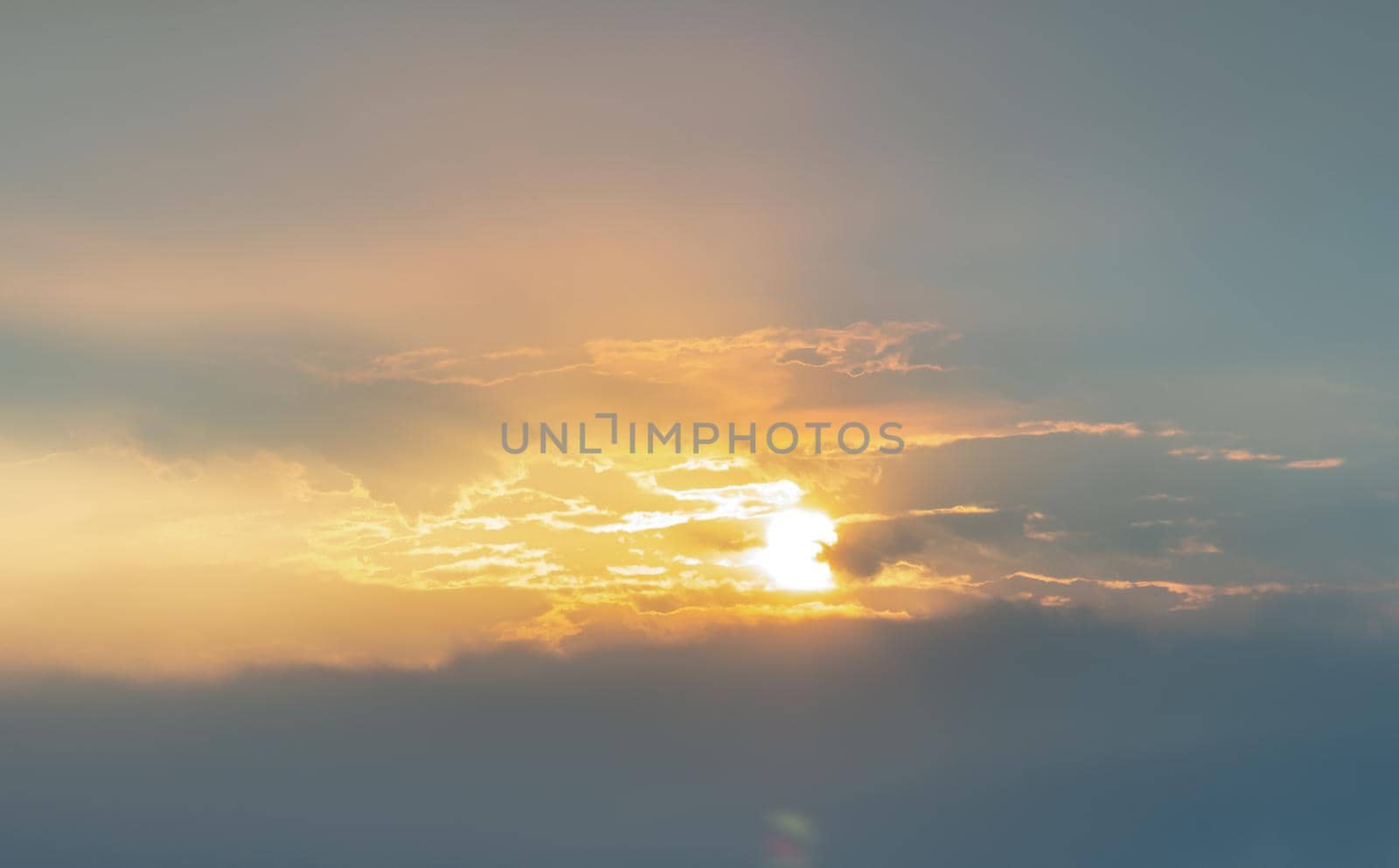 Beautiful sunset sky above clouds with dramatic light, Beautiful blazing sunset landscape, Horizon. Warm Colours, copy space.