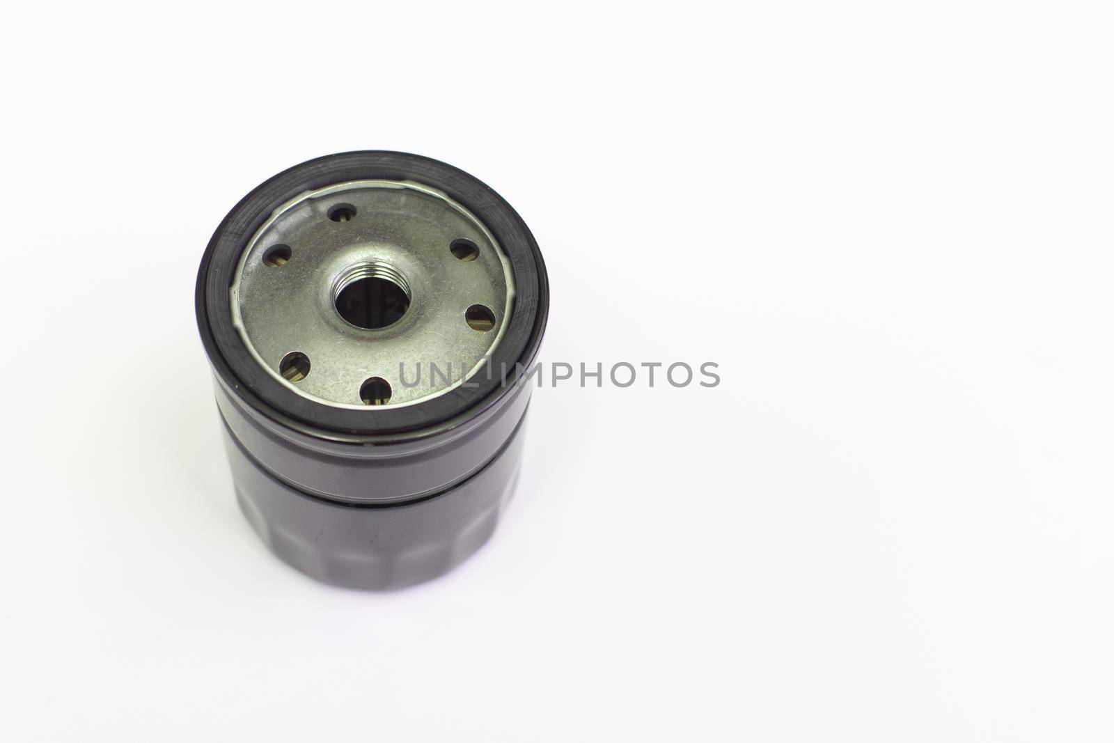 The car's oil filter is new. Close-up. Isolated on a white background. Selective focus.