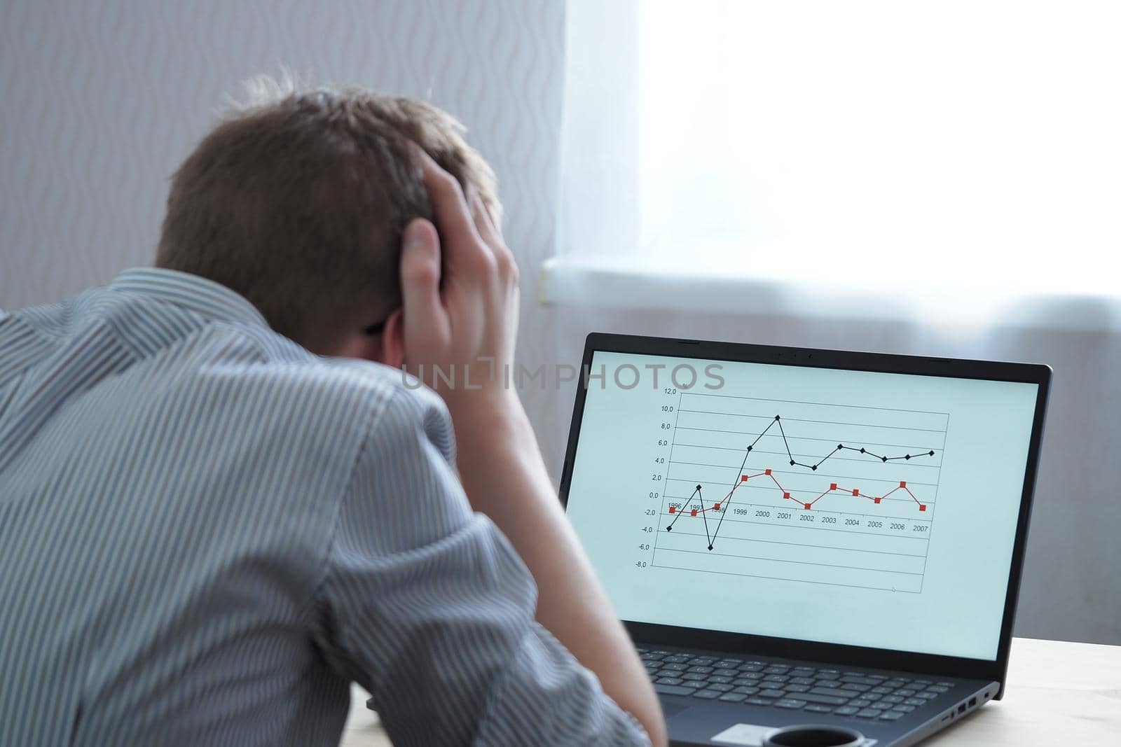 Distance learning, a young person, a student looks at, analyzes the schedule. High quality photo