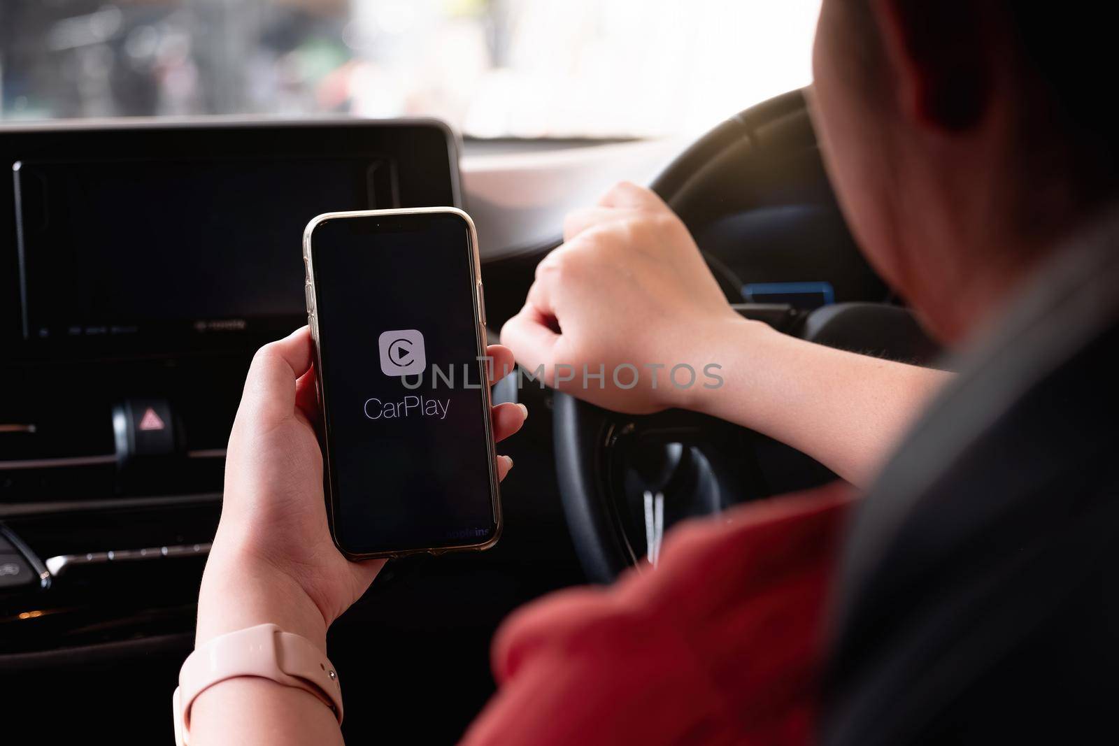 CHIANG MAI, THAILAND - MAR 28, 2021: Apple CarPlay starting up on an iPhone X connected to a new car.