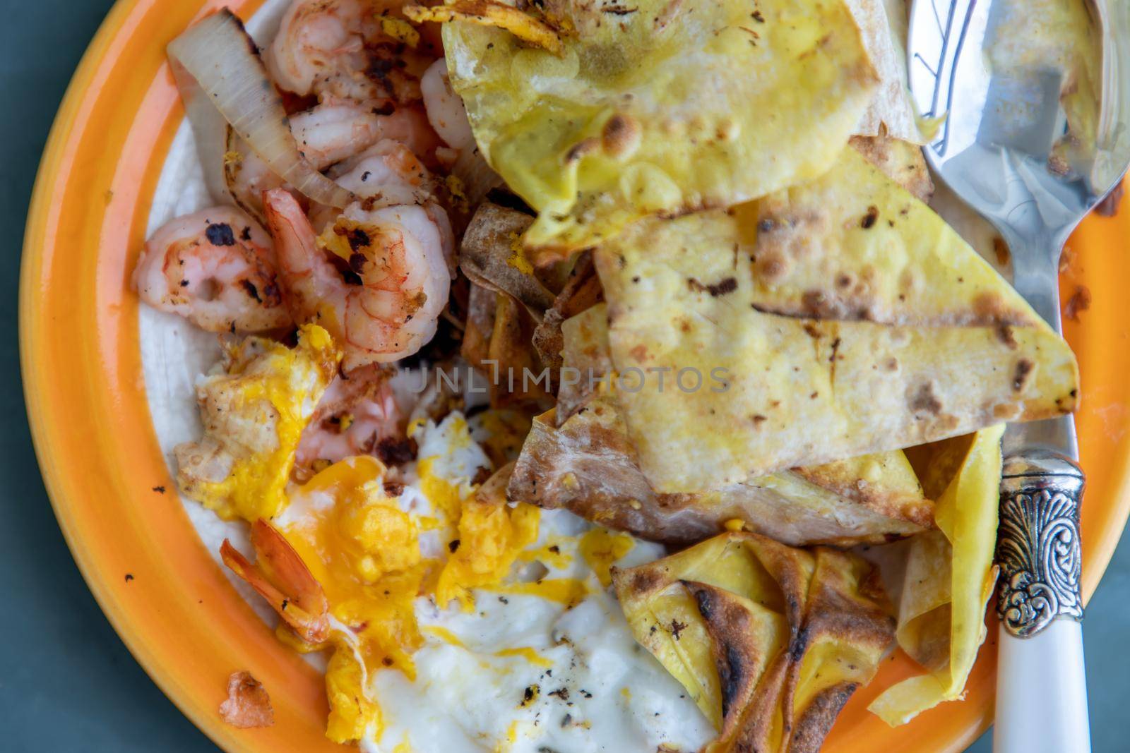 Breakfast with Omelet, Baked Shrimp, Onion and Deep fried Dumplings. Top view, Selective focus.
