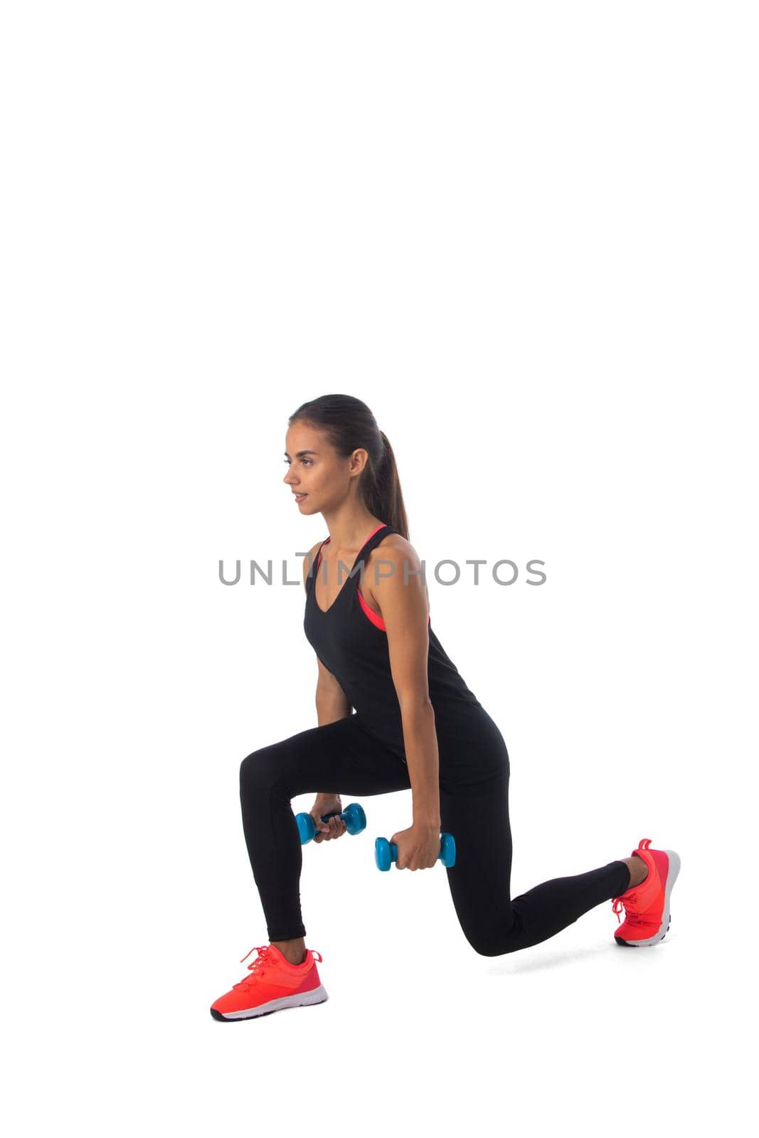 Healthy hispanic fitness girl with dumbbells working out lunge isolated on white background