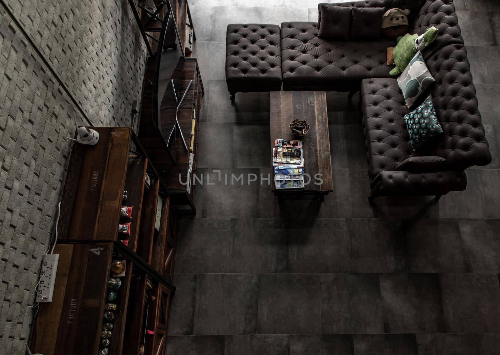 Bangkok, Thailand - 15 Dec 2019 : Minimalist modern living room with leather sofa and brick wall in loft style, Top view.