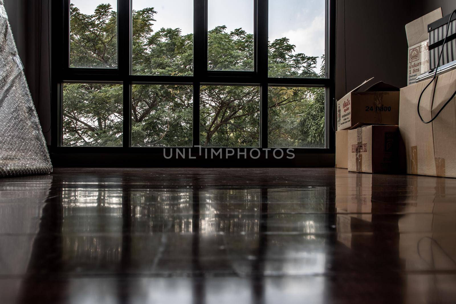 Bangkok, Thailand - 15 Dec 2019 : Empty room with Storage box and windows in loft style. Wooden floor and brick wall in a modern interior.