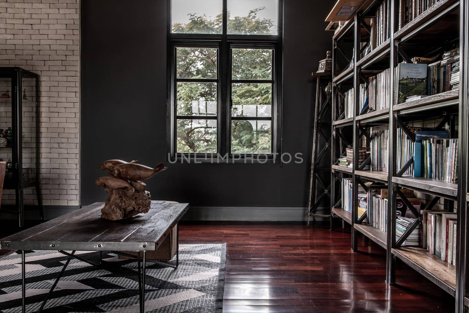 Bangkok, Thailand - 15 Dec 2019 : Minimalist modern living room with wooden table and brick wall in loft style.