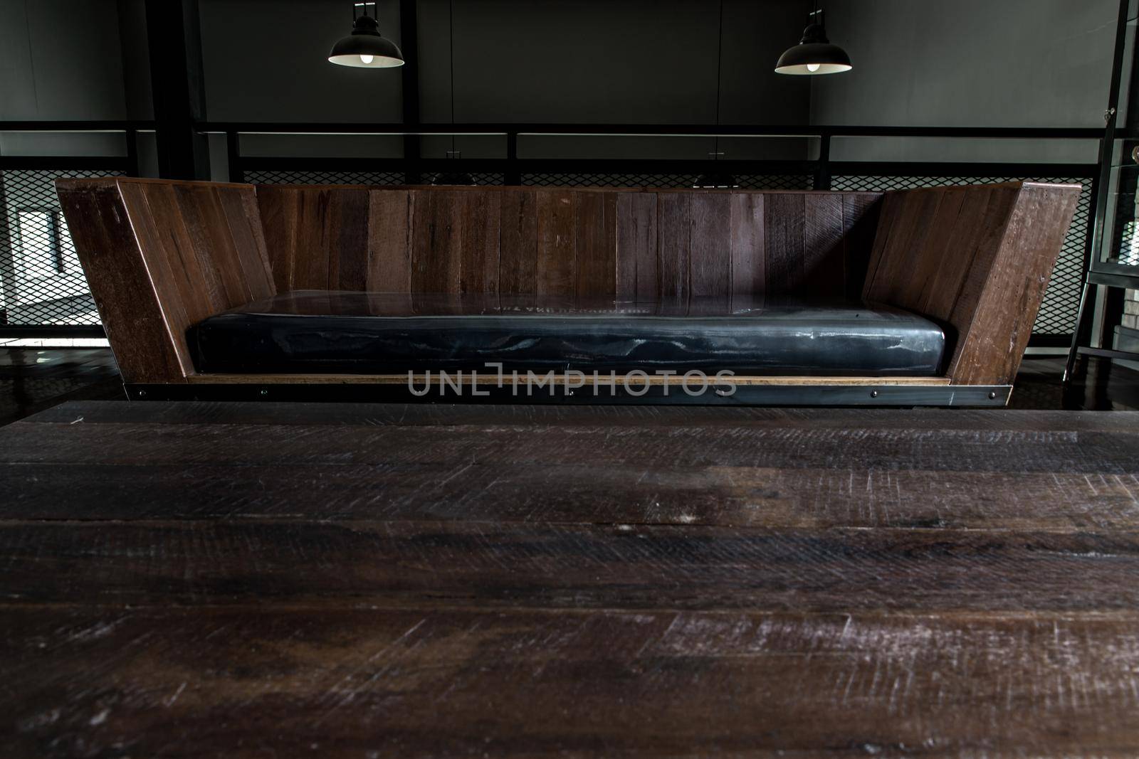 Bangkok, Thailand - 15 Dec 2019 : Living room in industrial style with sofa and wooden table on mezzanine floor.