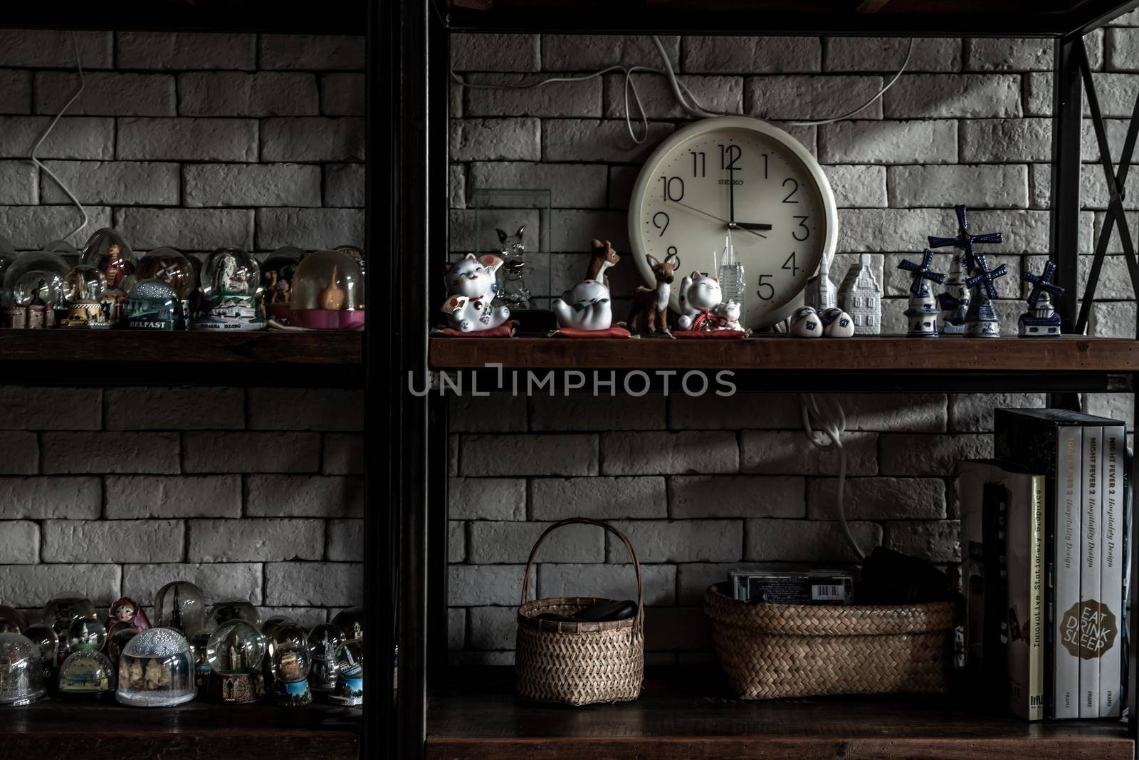 Bangkok, Thailand - 15 Dec 2019 : Souvenir and collectible objects from different cities of the world on books shelf in loft style home, Selective focus.