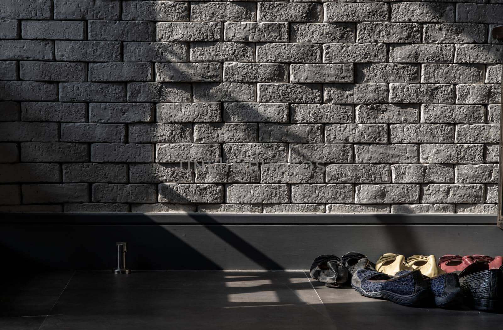 Bangkok, Thailand - 15 Dec 2019 : The sunlight shines on Shoe Holder in loft style home.