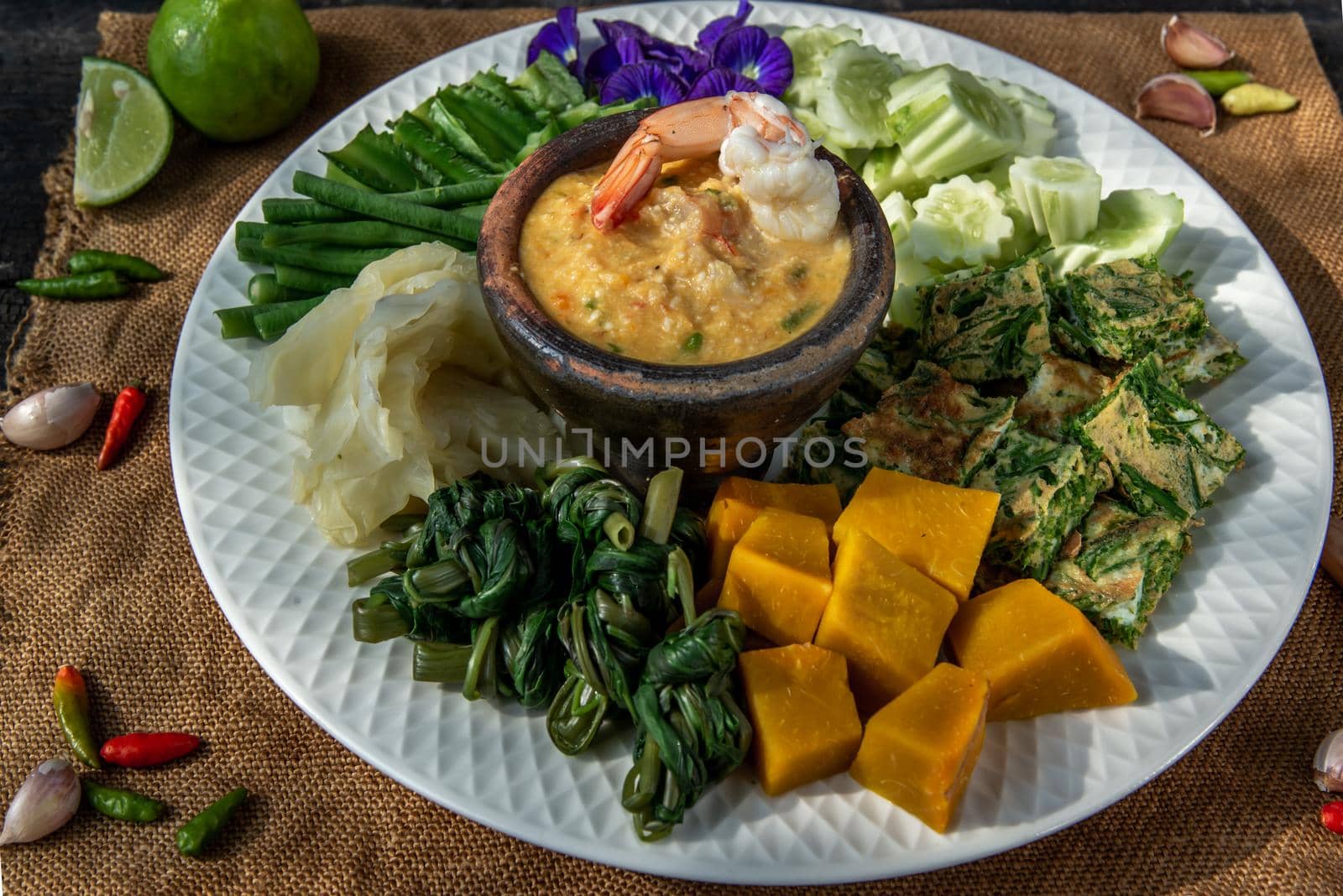Thai Traditional Local Food : Shrimps chili dip or nam prik with shrimps (Nam Prik Goong Sod) with blanched vegetables and cha-om omelets.