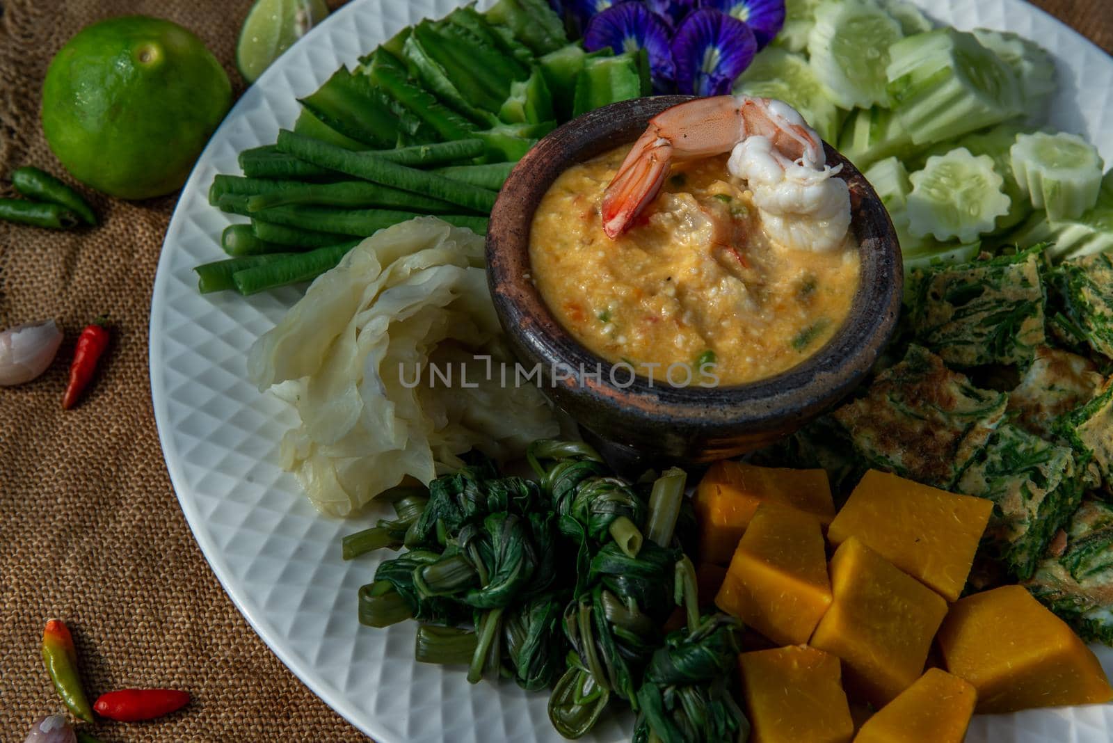 Thai Traditional Local Food : Shrimps chili dip or nam prik with shrimps (Nam Prik Goong Sod) with blanched vegetables and cha-om omelets.