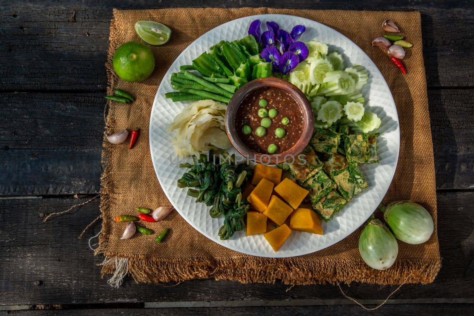 Thai Traditional Local Food : Spicy Shrimp Paste Dip or Fried shrimp paste sauce (Nam Prik Kapi) with blanched vegetables and cha-om omelets.