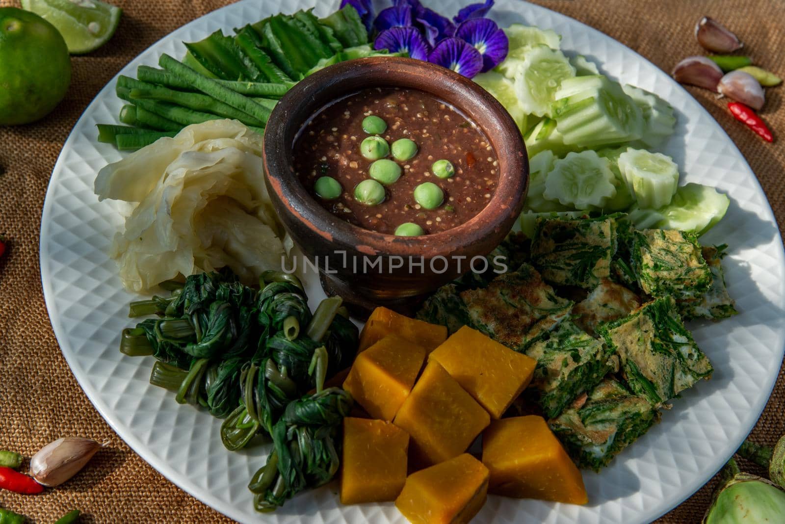 Thai Traditional Local Food : Spicy Shrimp Paste Dip or Fried shrimp paste sauce (Nam Prik Kapi) with blanched vegetables and cha-om omelets.