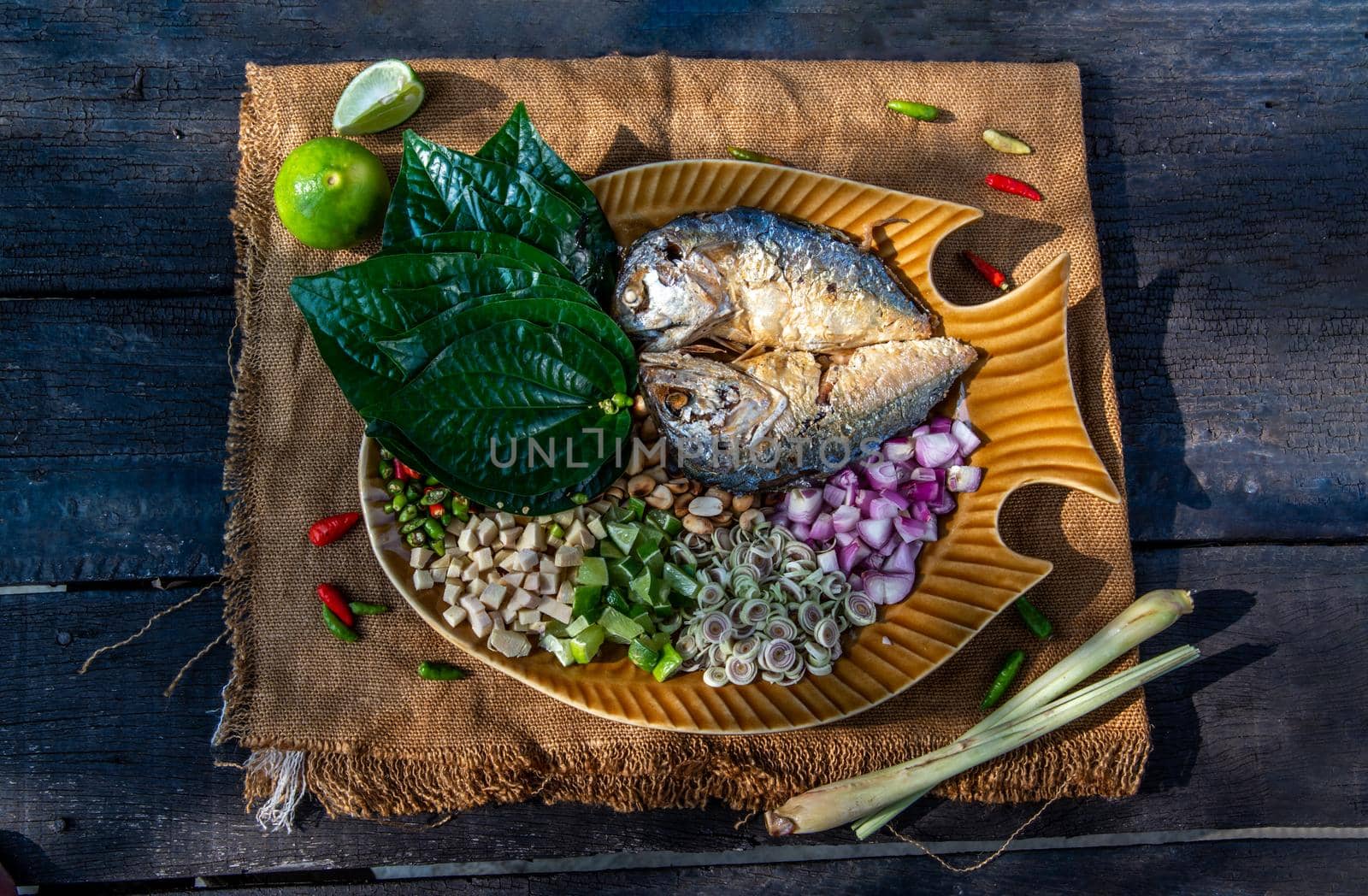 Thai Traditional Food : Fried mackerel served with fresh vegetable and herb, This food is thai food call Meuang Mackerel (Maing-Pla-too) menu.