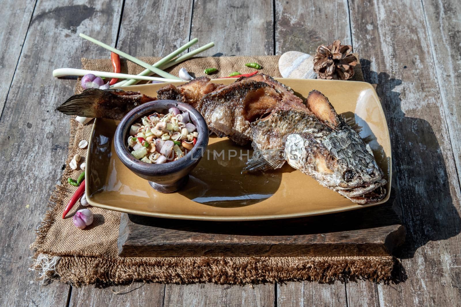 Deep fried whole Snakehead with spicy lemongrass salad, Thai food for health.