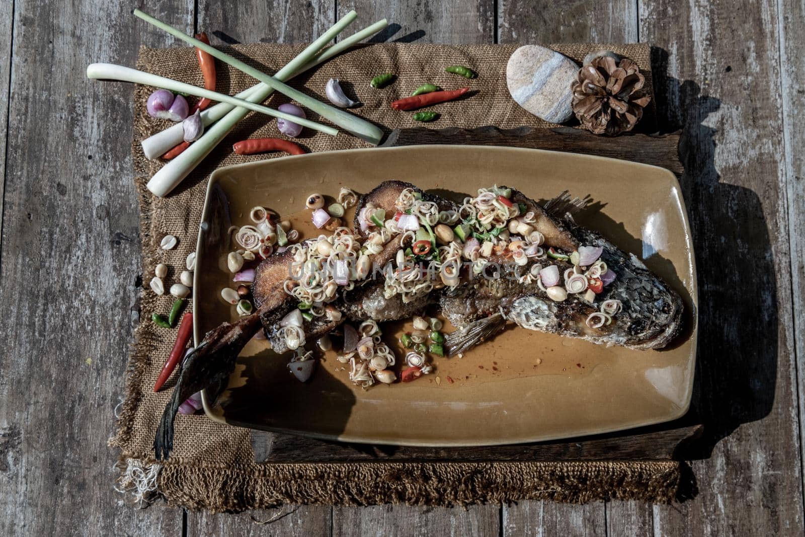 Deep fried whole Snakehead with spicy lemongrass salad, Thai food for health.