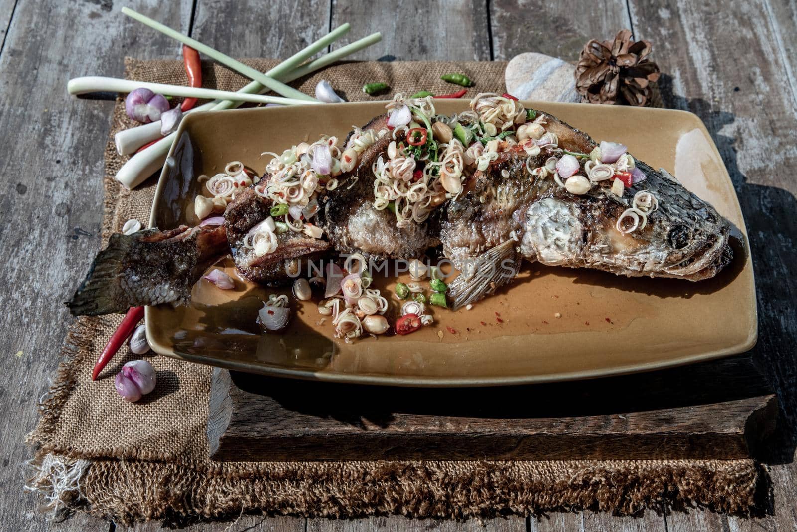 Deep fried whole Snakehead with spicy lemongrass salad, Thai food for health.