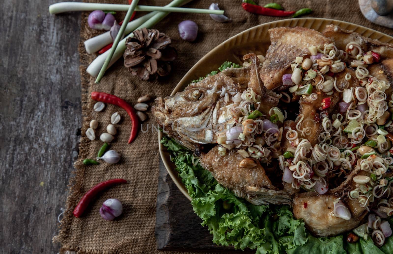 Deep fried whole Tubtim fish with spicy lemongrass salad, Thai food for health.