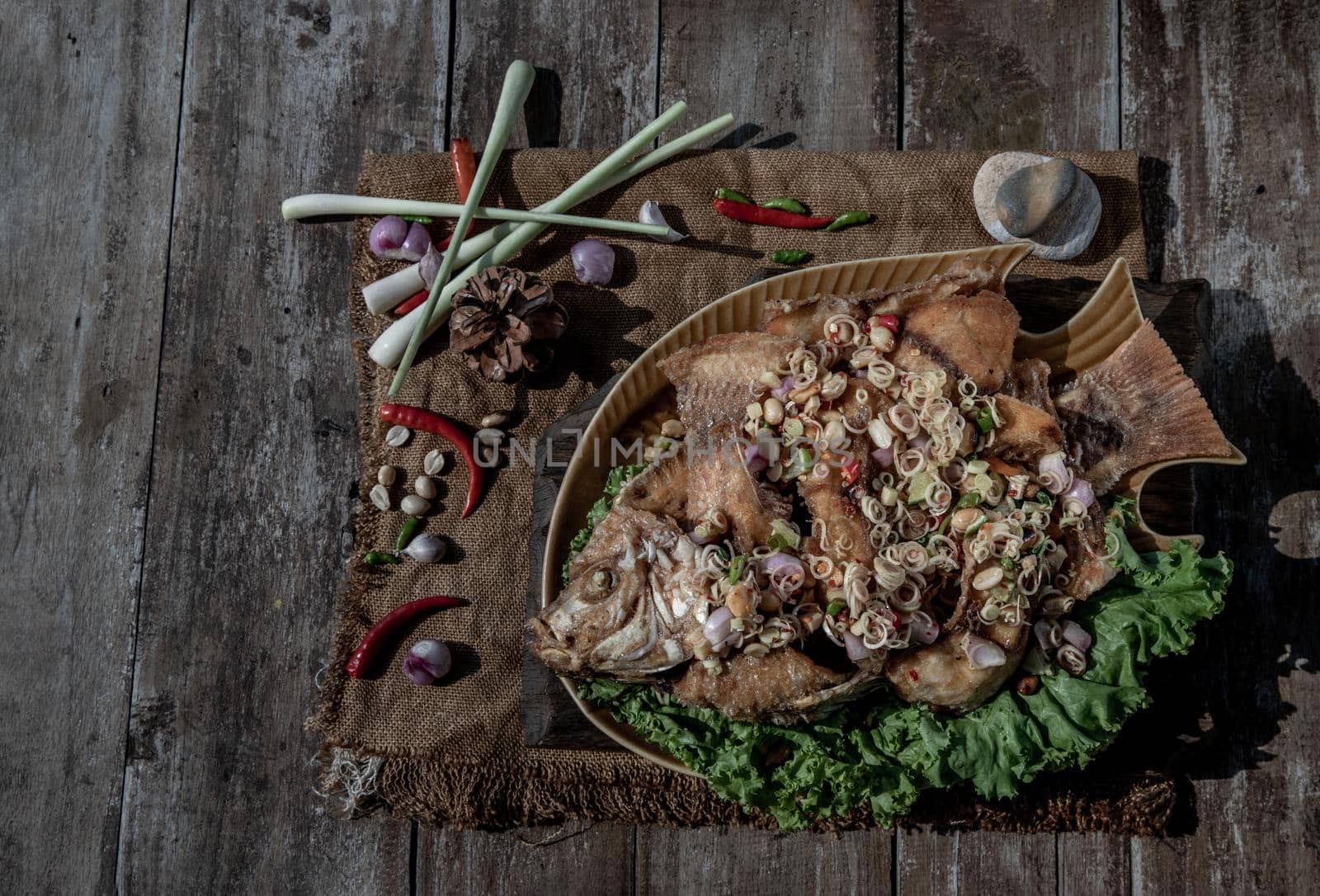 Deep fried whole Tubtim fish with spicy lemongrass salad, Thai food for health.