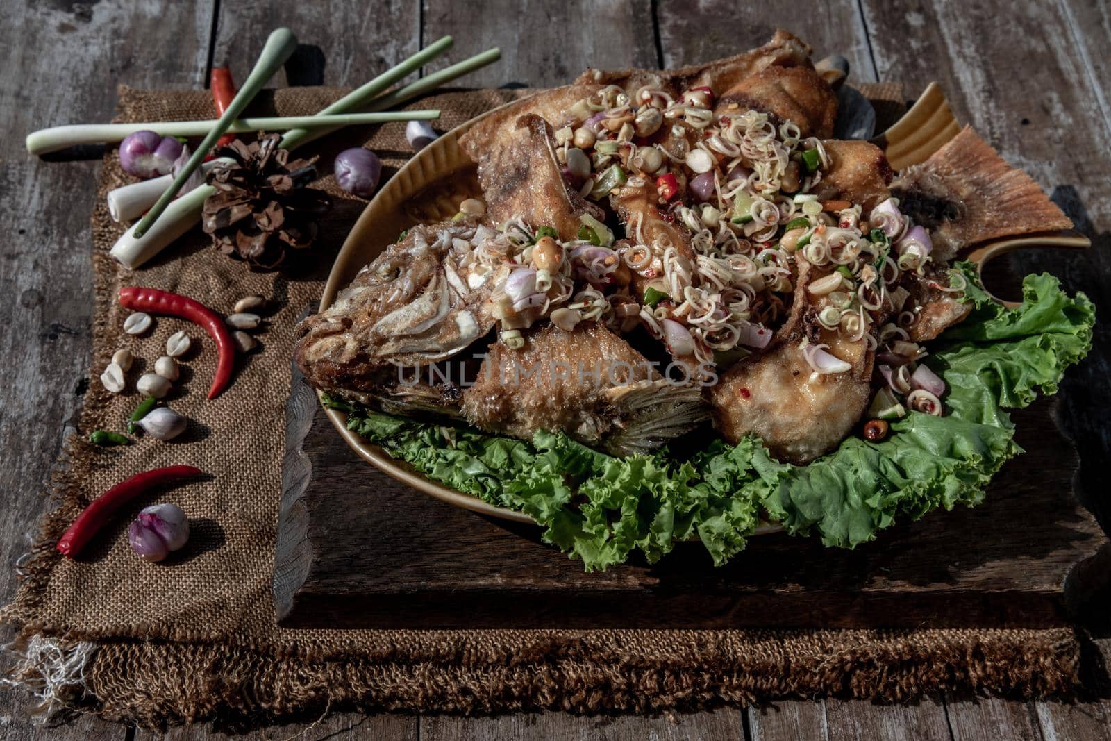Deep fried whole Tubtim fish with spicy lemongrass salad, Thai food for health.