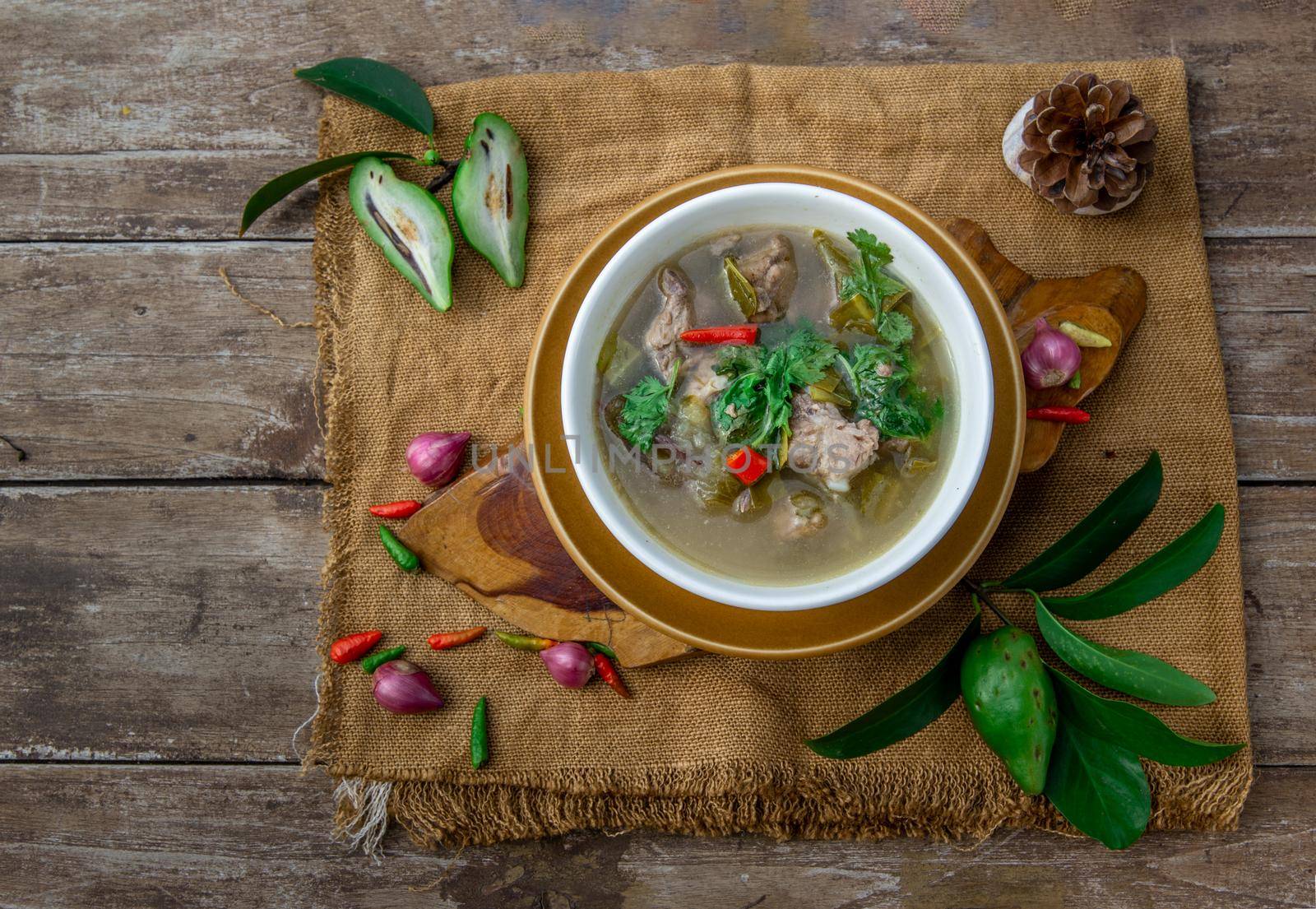 Pork spare rip Madan soup (Kra Dook Moo Tom Ma-Dun) in a white bowl, Traditional Thai food, Top view.