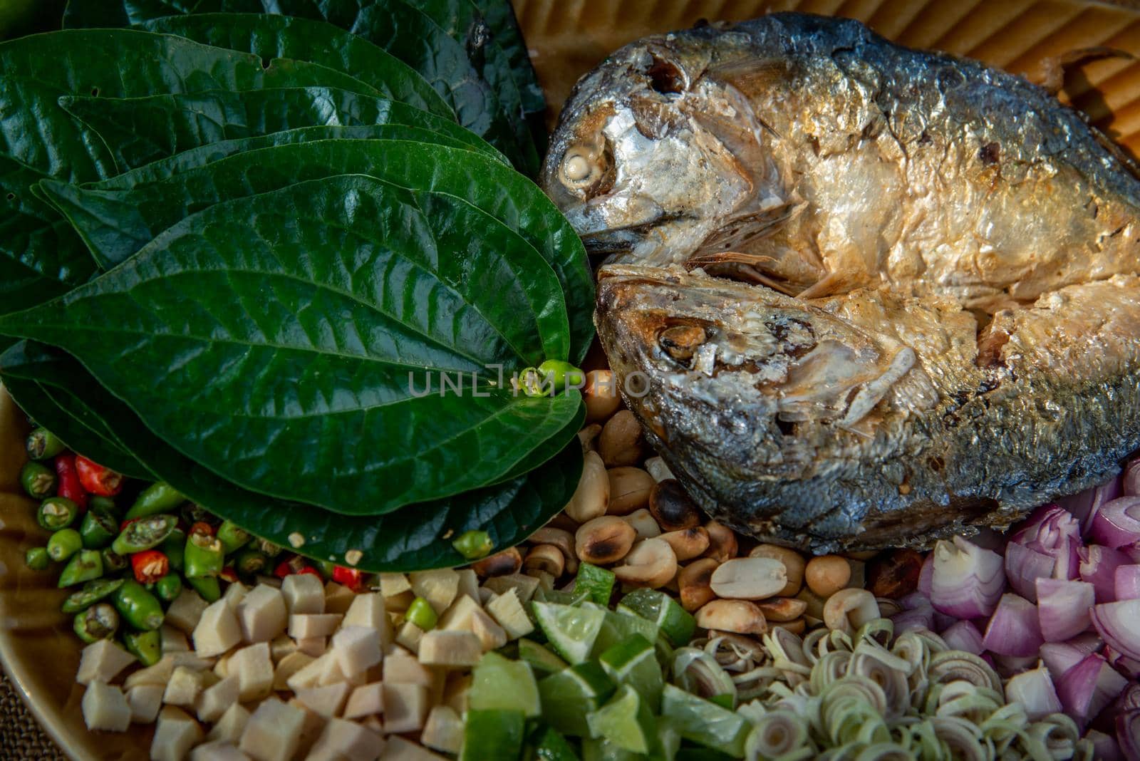 Thai Traditional Food : Fried mackerel served with fresh vegetable and herb, This food is thai food call Meuang Mackerel (Maing-Pla-too) menu.